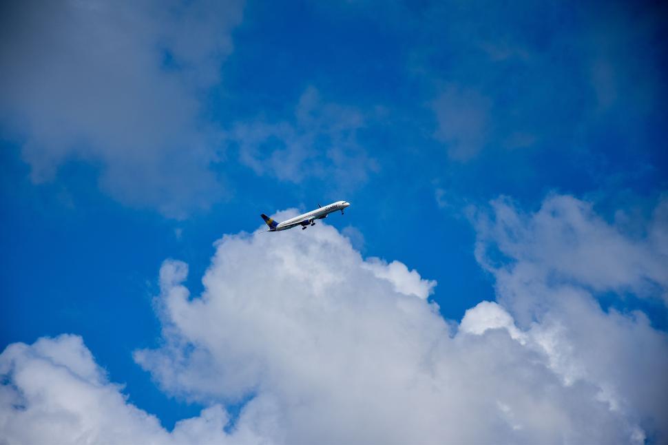 Free Image of Airplane and white clouds  