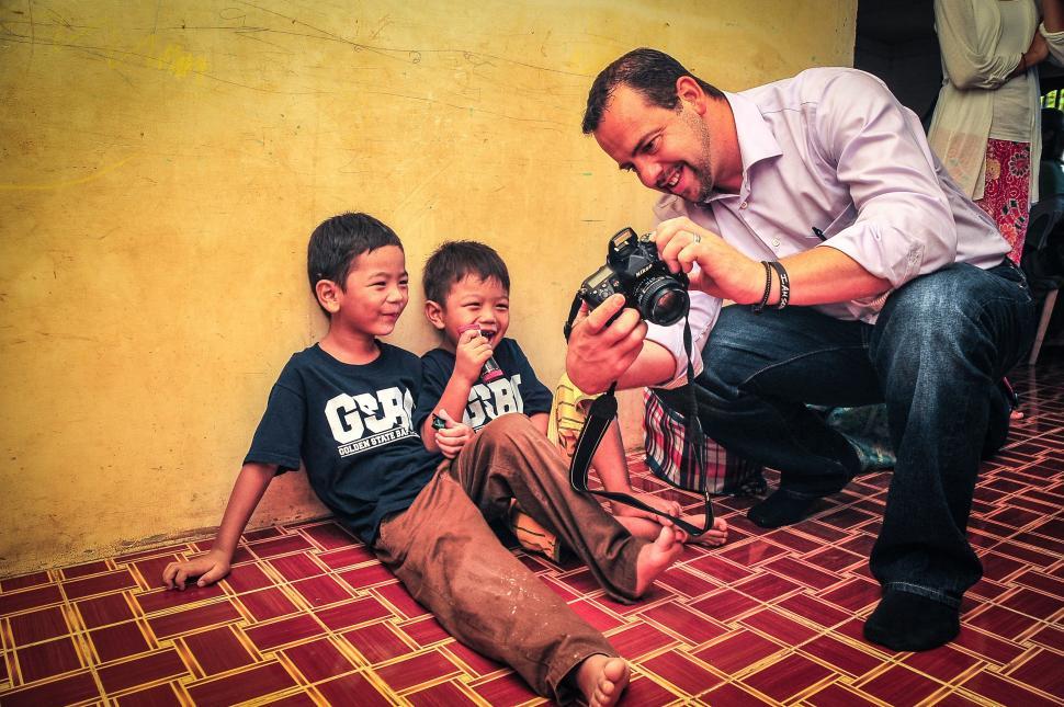 Free Image of Orphan Kids and Photographer  
