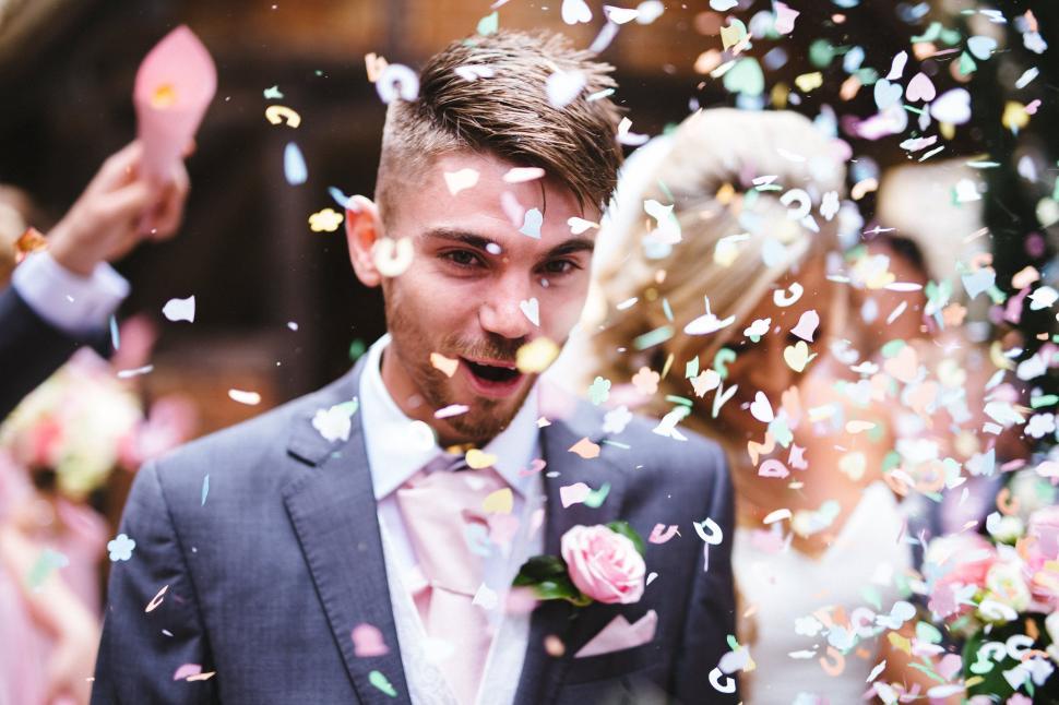 Free Image of Confetti Over Bride And Groom At Wedding  