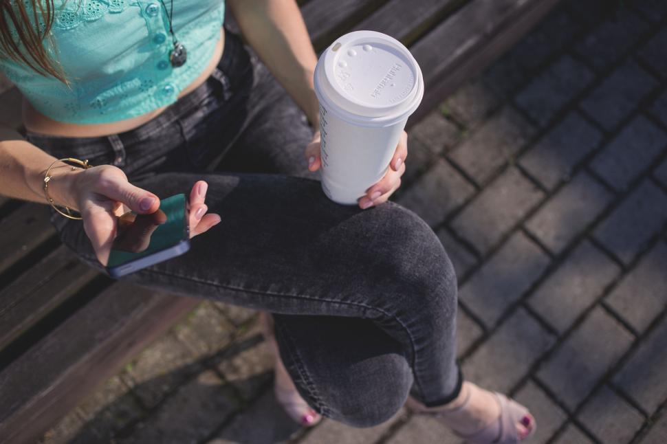 Free Image of Woman with disposable coffee cup 