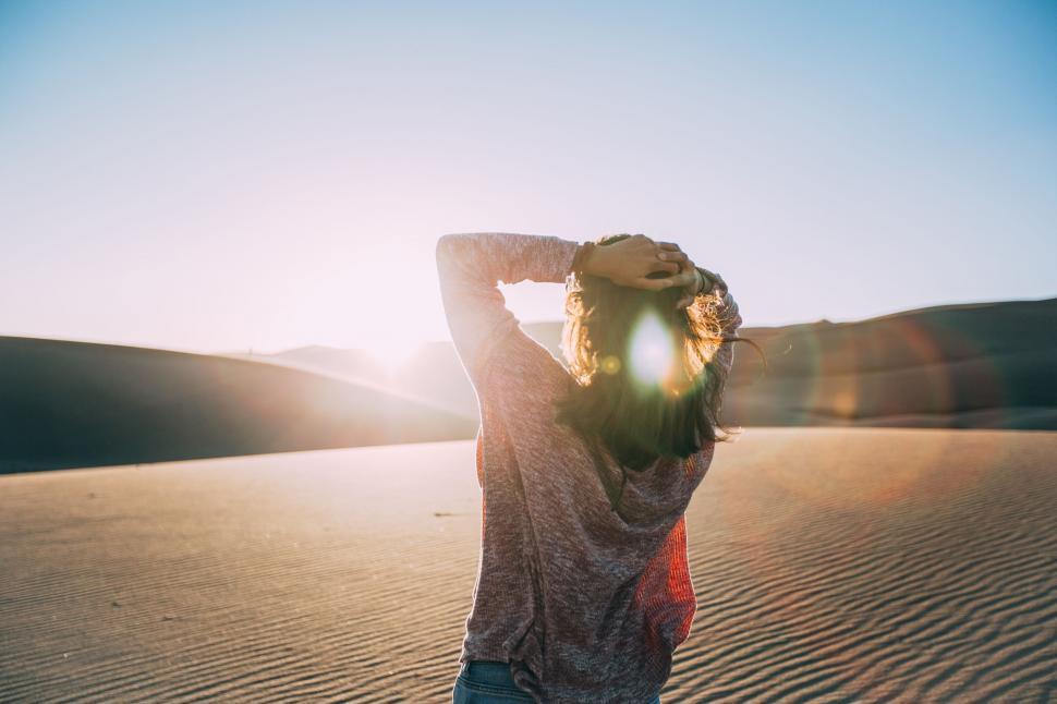 Free Image of Sun glare on Woman in Desert  