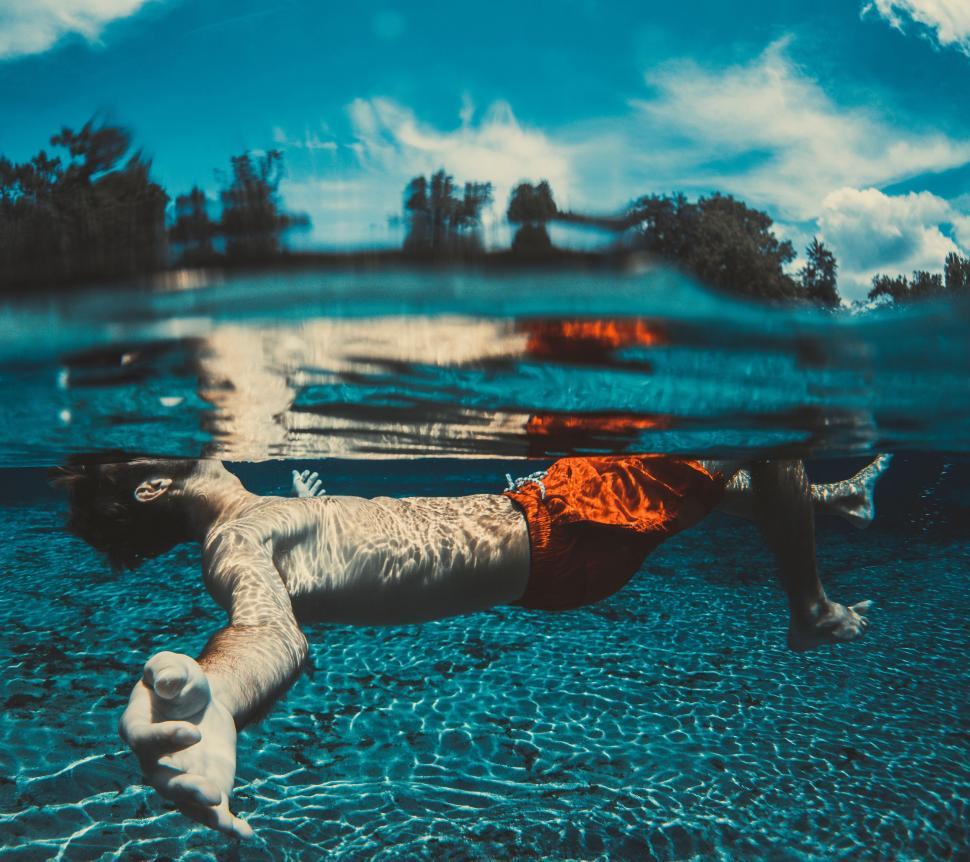 Free Image of Man under swimming pool  