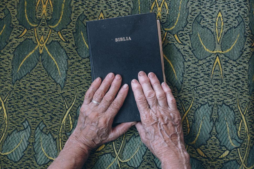 Free Image of Hands on Bible 