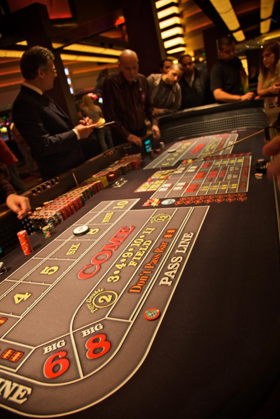 Free Image of Casino Table With People Standing Around It 