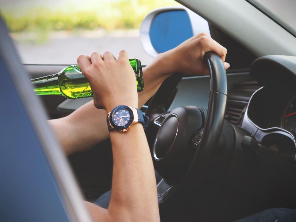 Free Image of Unrecognizable man drinking and driving 
