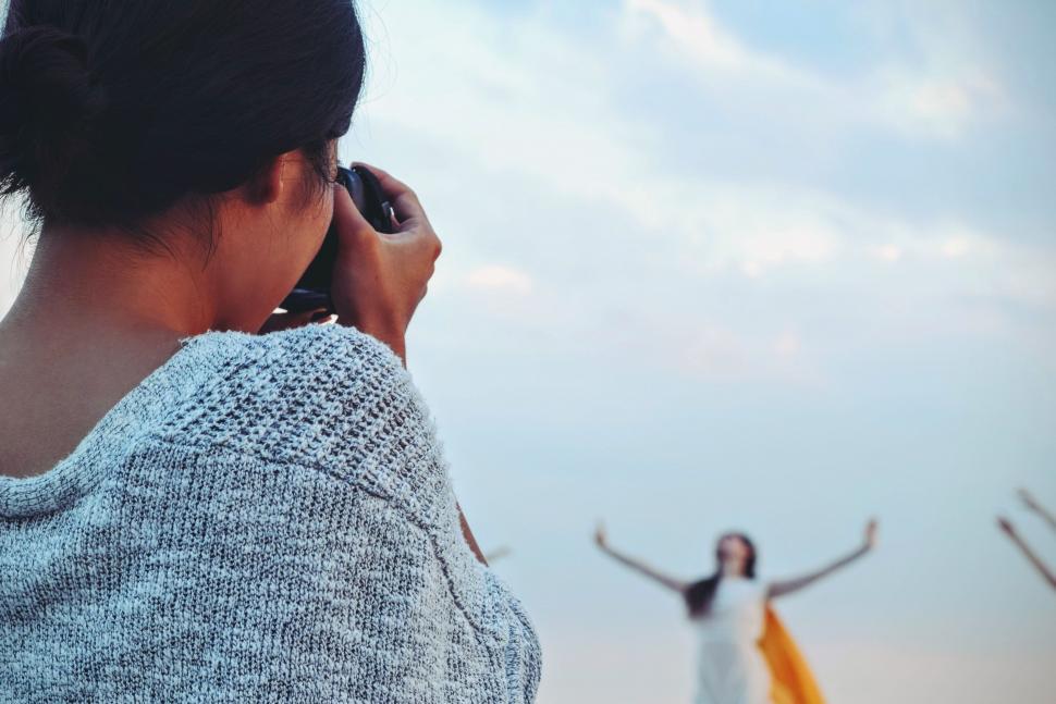 Free Image of Woman Photographer with Dancer in the blur background 