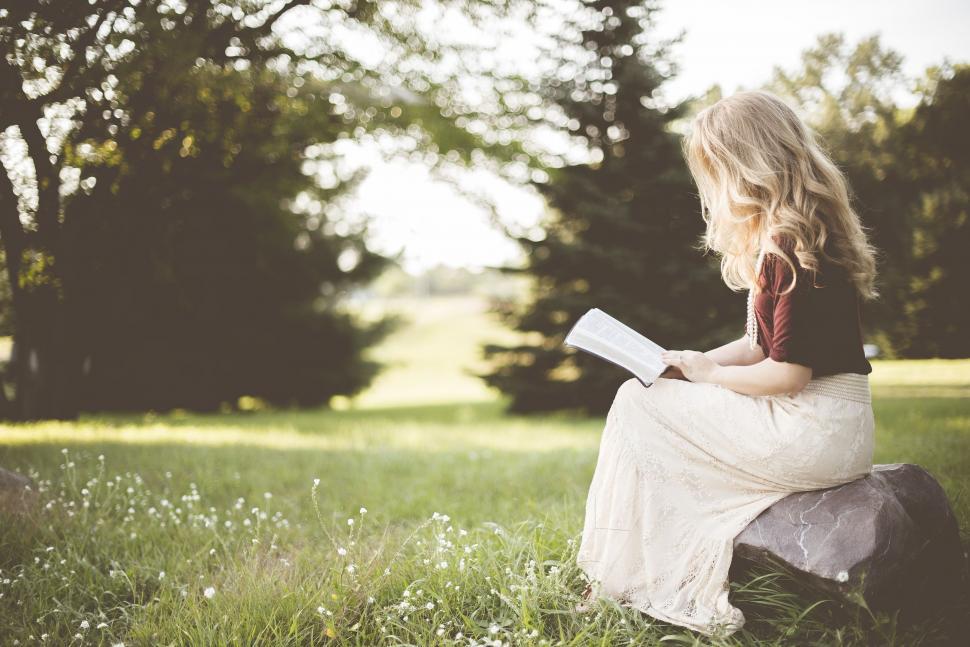 Free Image of Woman sitting with book in the park  