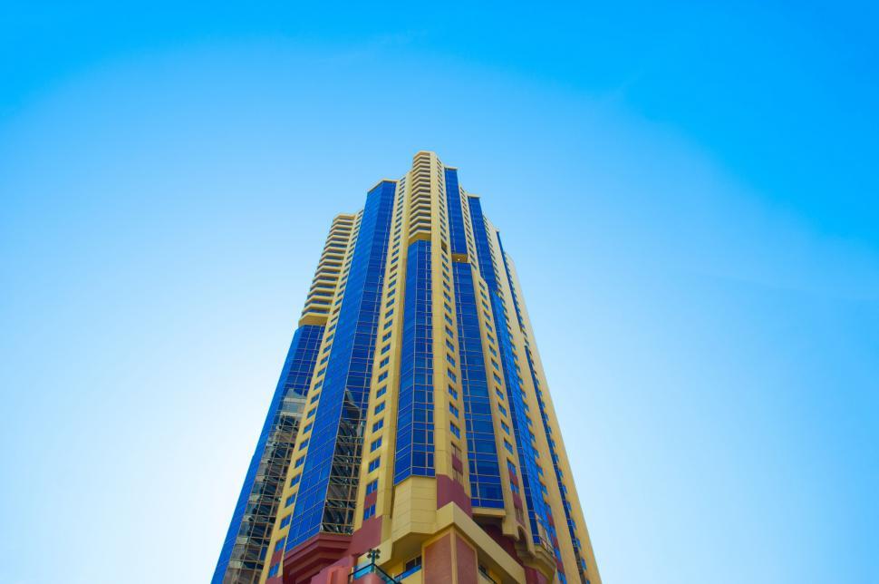 Free Image of Blue Yellow Skyscraper from below  