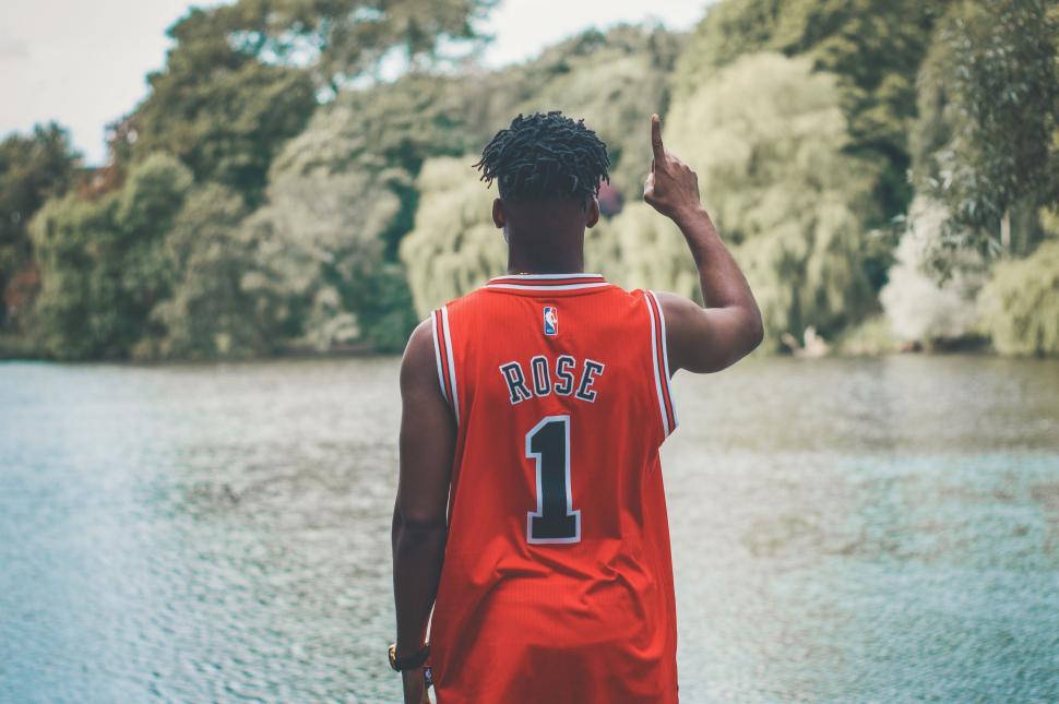 Free Image of Backside view of Basketball Player with river and mountains  