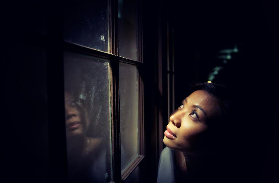 Free Image of Dark View of Woman at window  