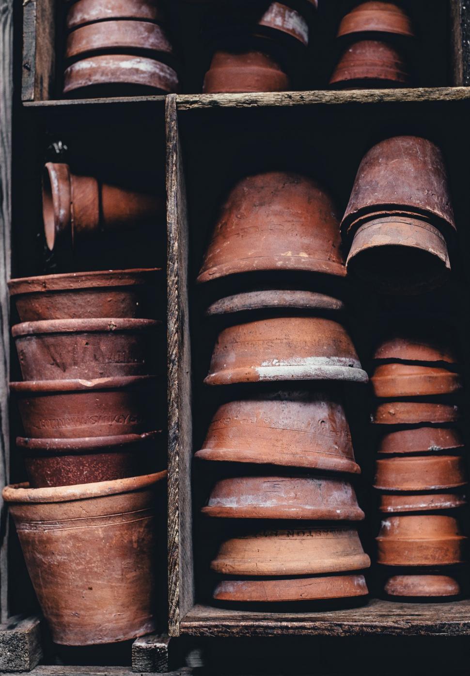 Free Image of Clay Flower Pots in Wooden Shelves  