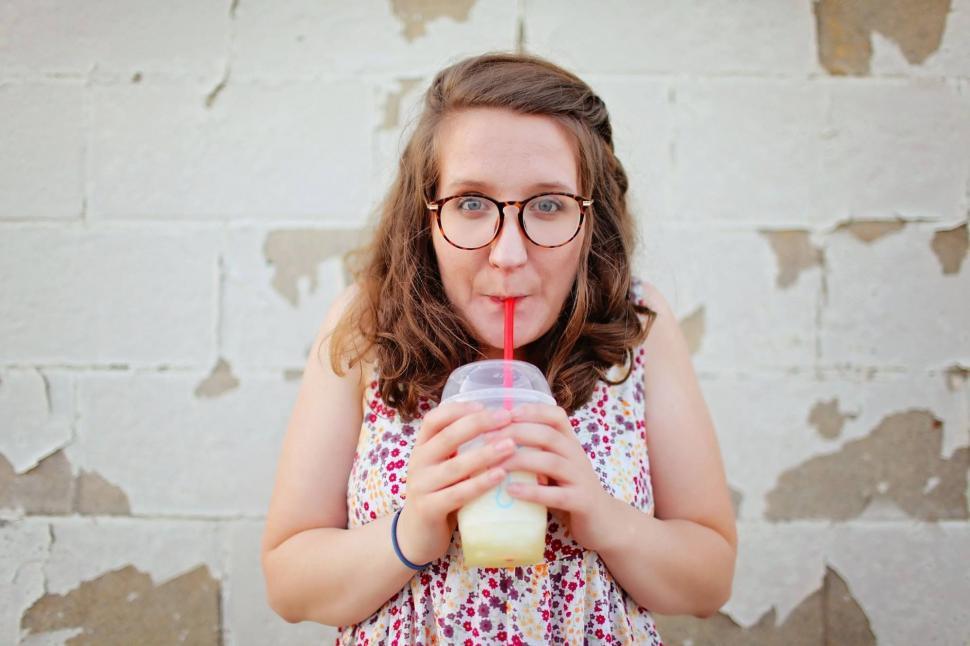 Free Image of Woman Drinking With Straw  