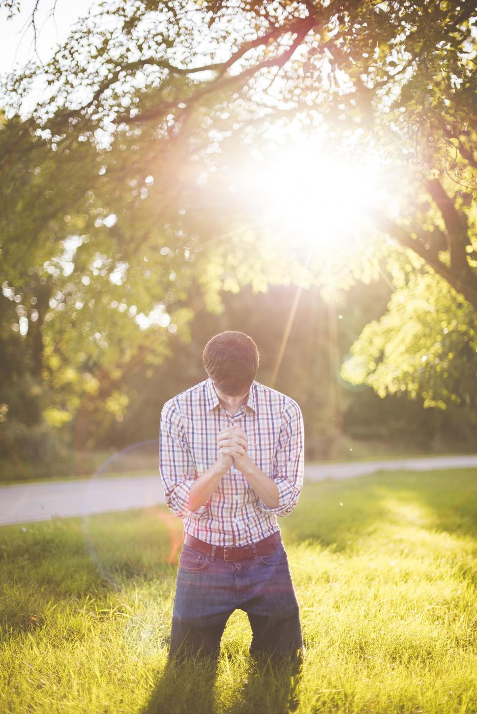 Free Image of Praying on Green Grass with Sunlight  