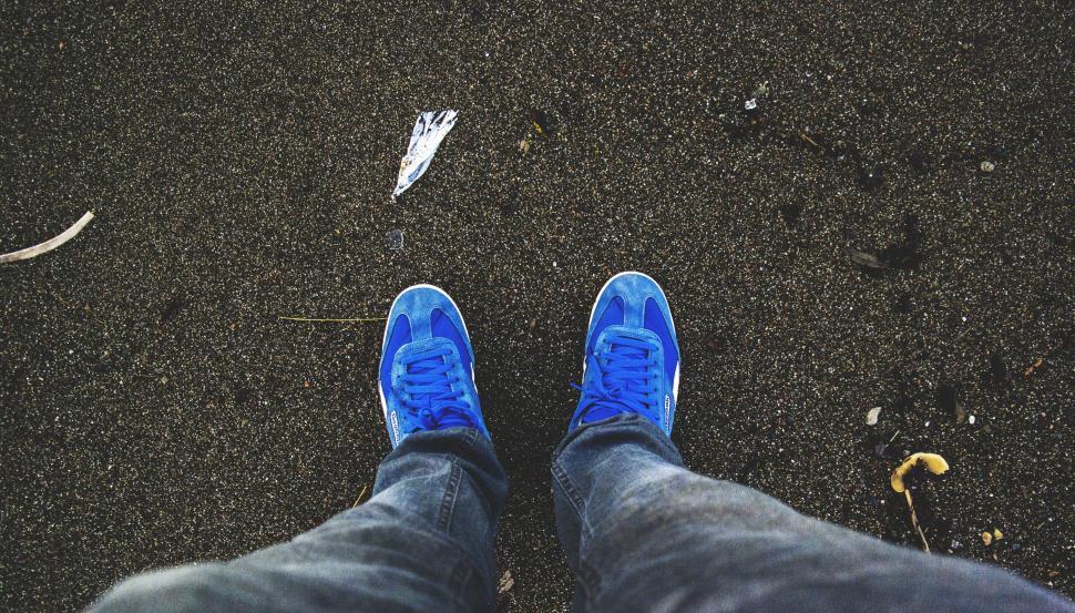 Free Image of Blue Shoes on black sand - Looking Down  
