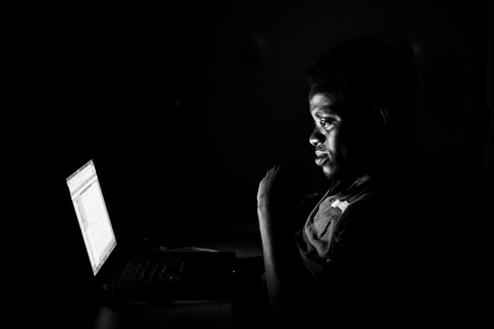 Free Image of Dark View of man working on laptop  