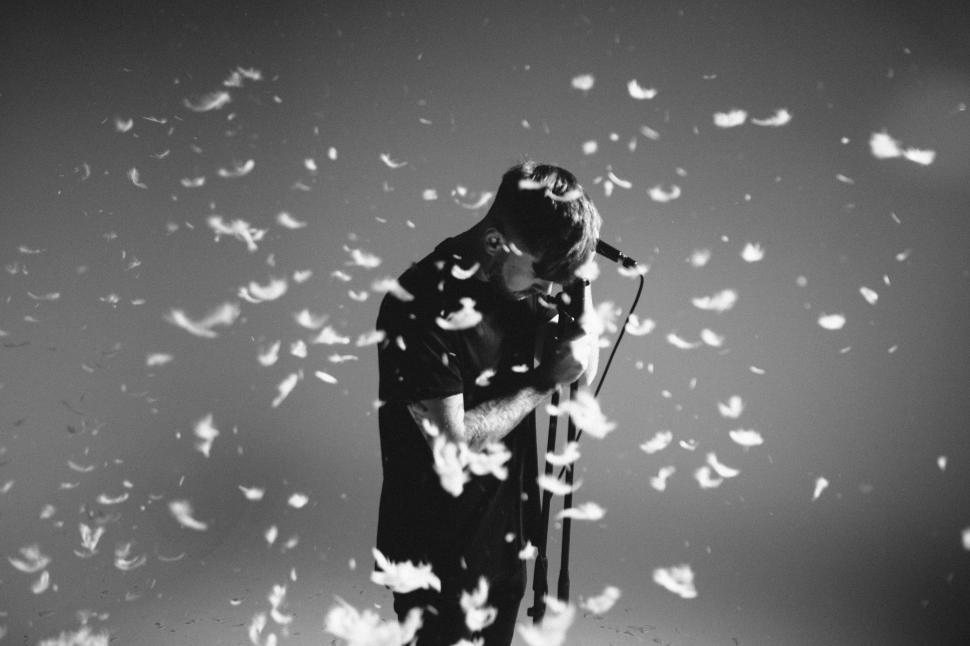 Free Image of Feather Confetti and Musician 