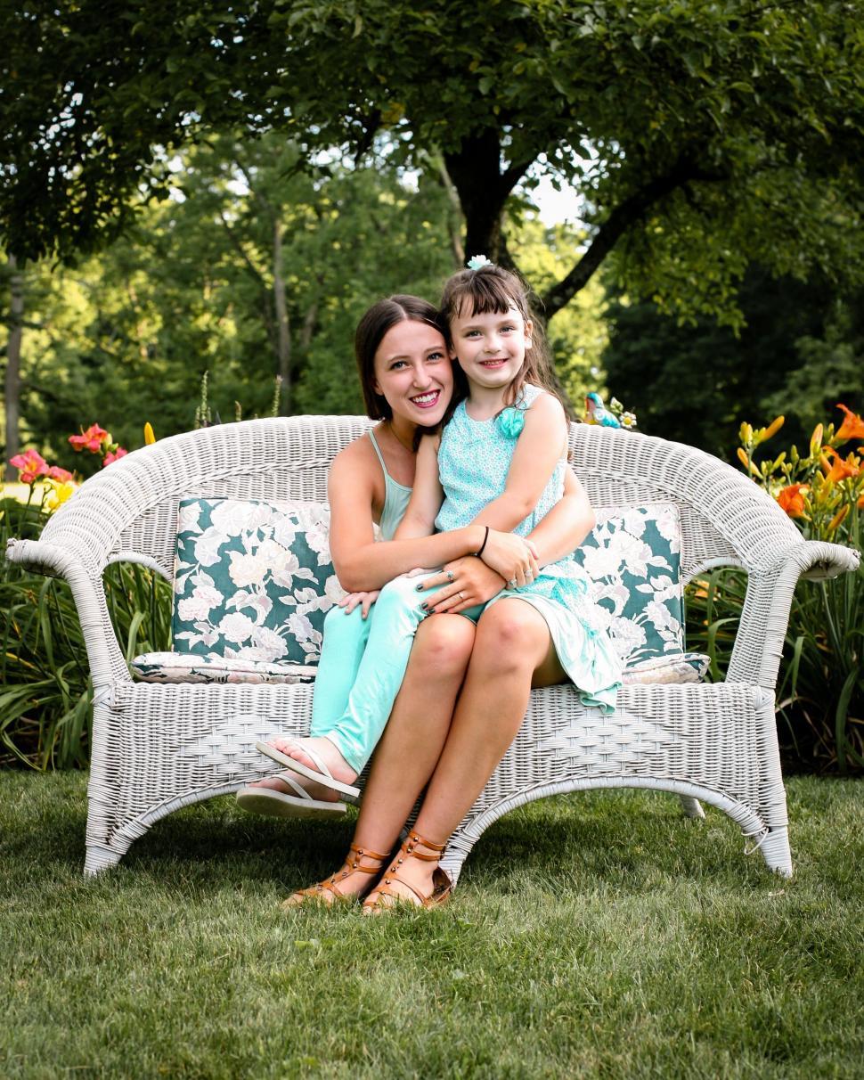 Free Image of Caucasian Woman and Girl Child on sofa in the garden  