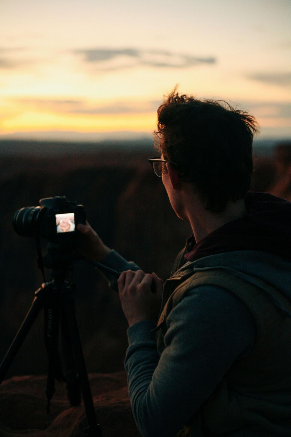 Free Image of Photographer with camera during sunset 