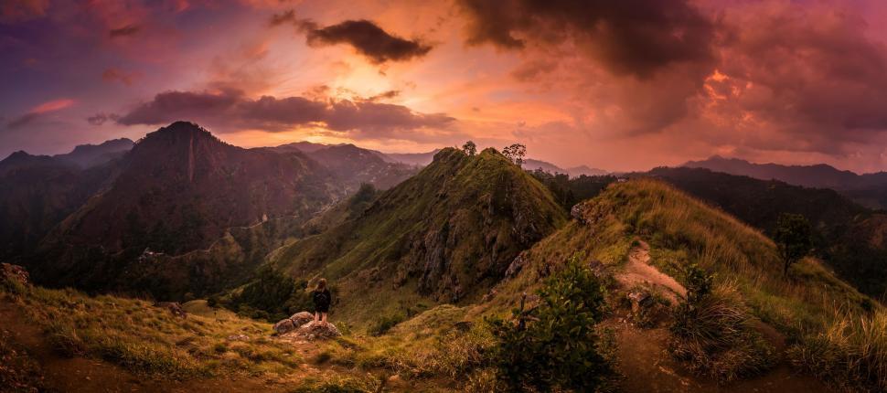Free Image of Green Mountains with woman during sunset  