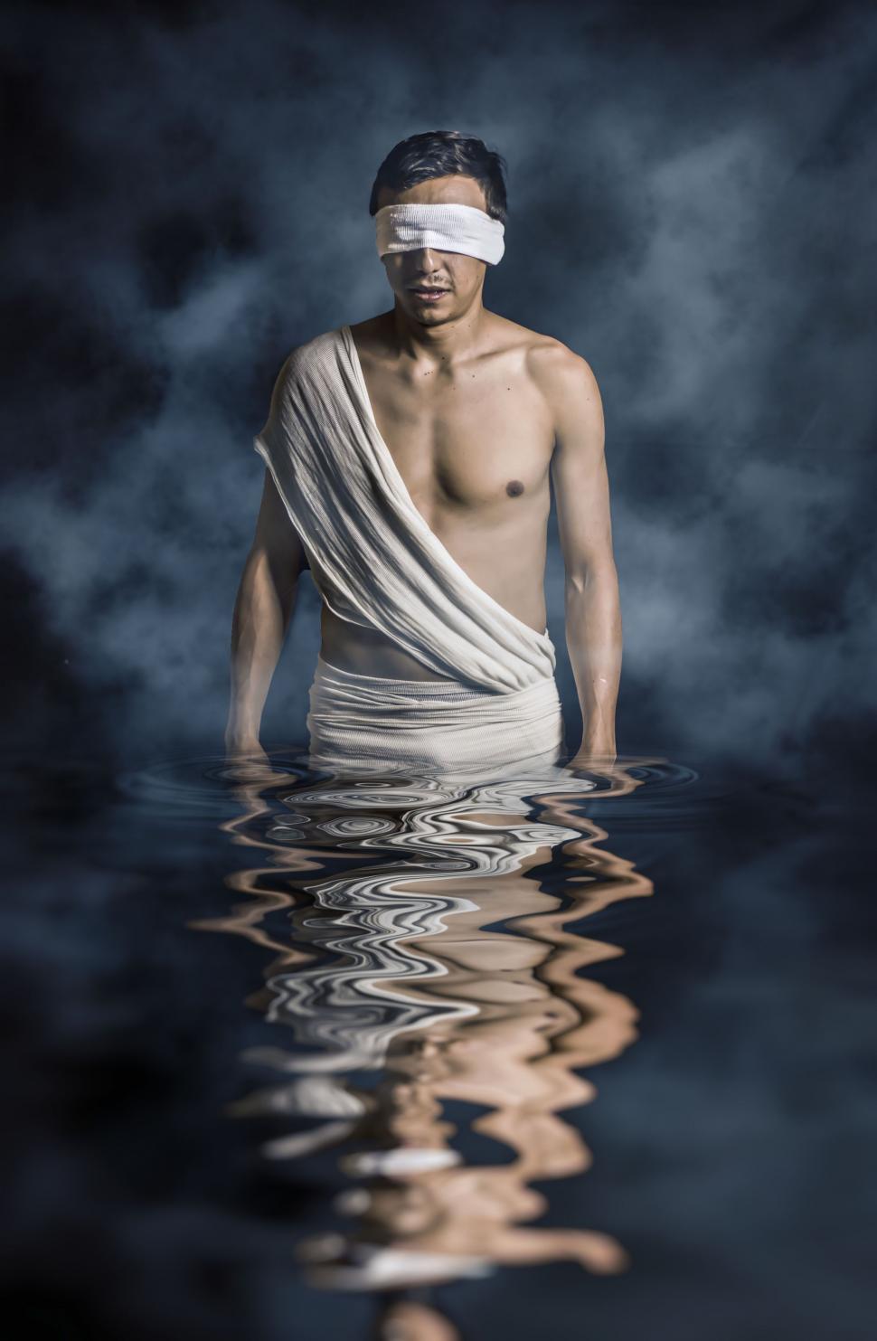 Free Image of Blindfolded Man Standing in Water 