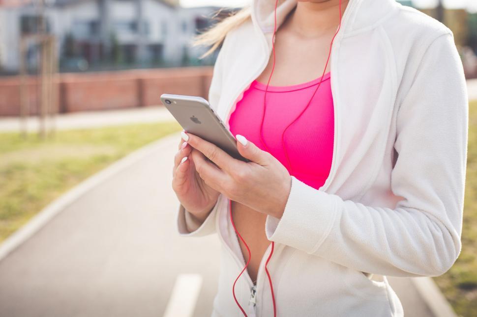 Free Image of Woman listening to music with iPhone  