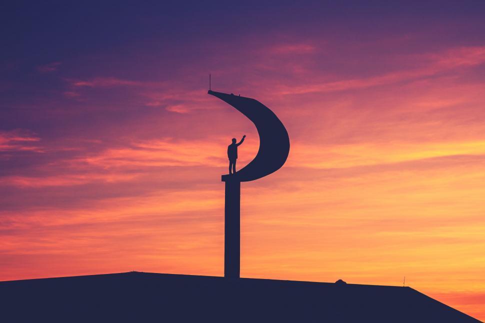 Free Image of Silhouette View of Sickle Tower with Man 
