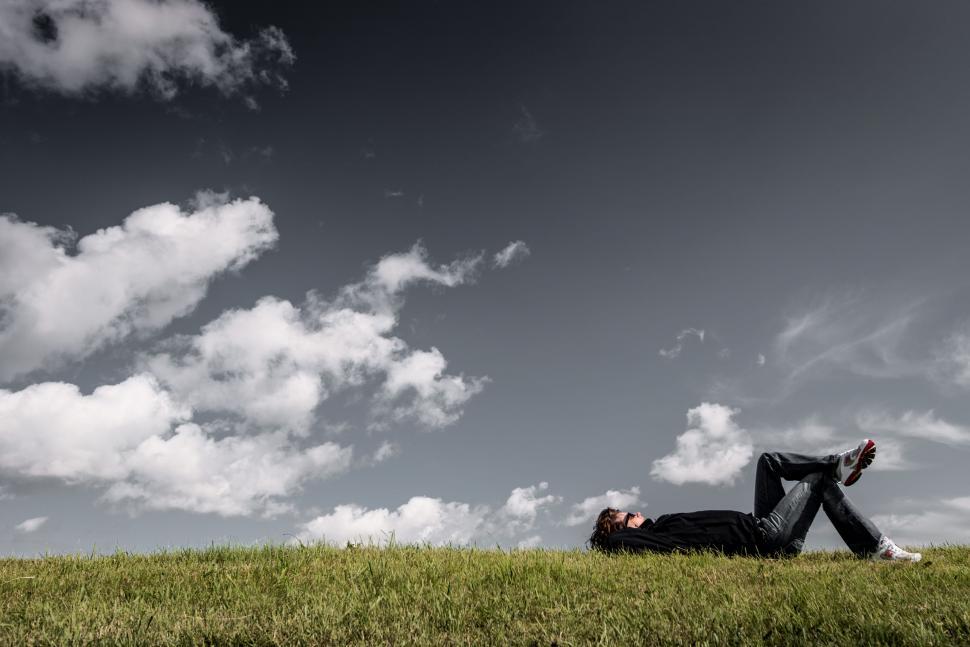 Free Image of Man relaxing on grass  