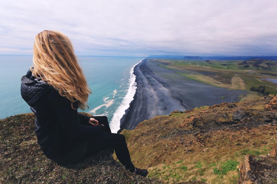 Free Image of Backside view of Woman Sitting on Cliff  