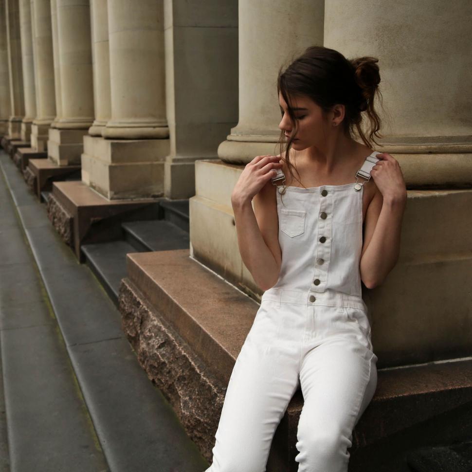 Free Image of Female Fashion Model Posing Around Concrete Pillars  