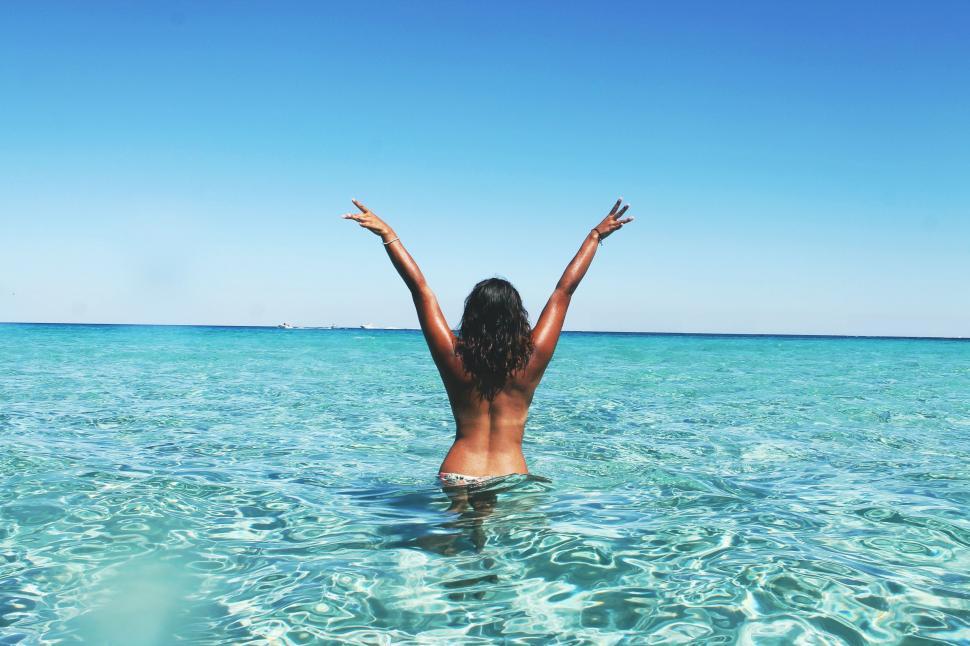 Free Image of Backside view of topless woman in water  