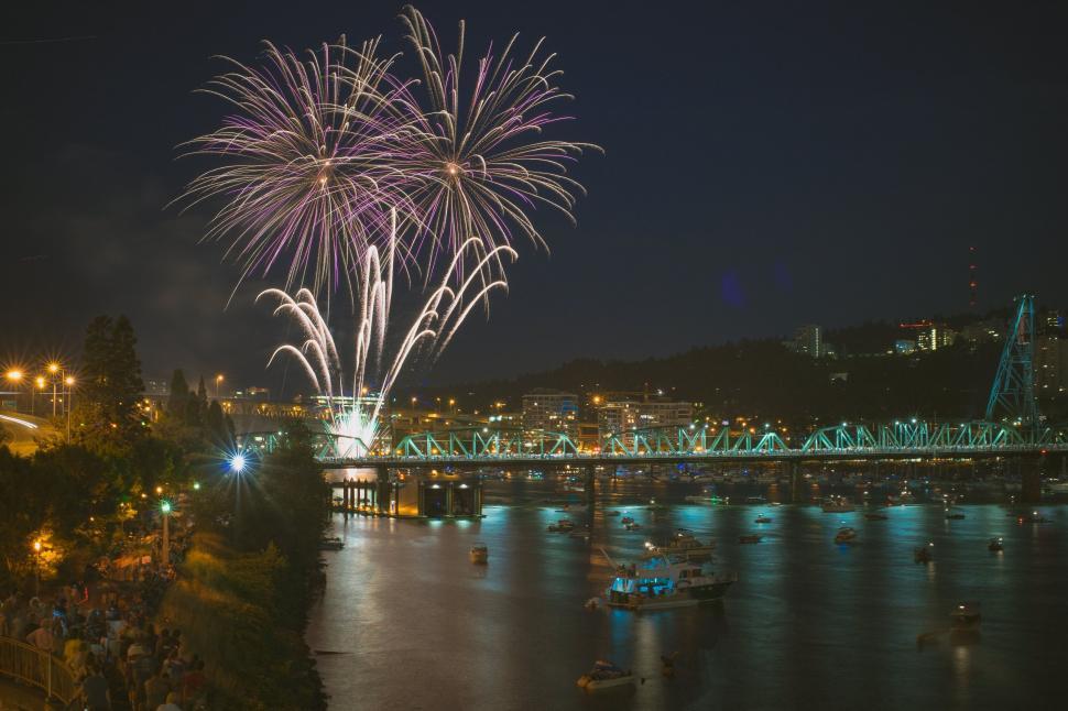Free Image of Fireworks at river bridge during night time 