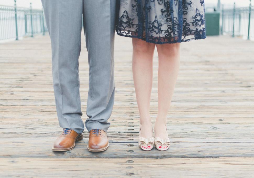 Free Image of Couple Feet Standing on Pier  
