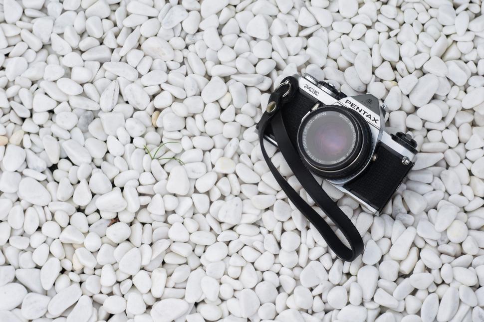 Free Image of Pentax Camera on pebble stones  