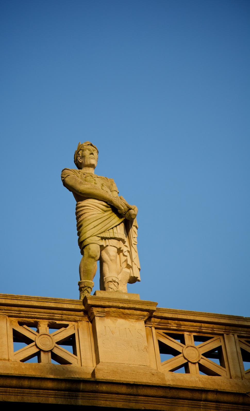 Free Image of Statue of Man Standing on Top of Bridge 
