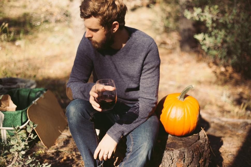 Free Image of Man with pumpkin and glass of wine  