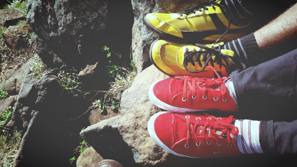 Free Image of Two Pairs of Shoes in Feet on mountain 