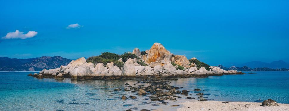 Free Image of Blue Sky and Sea with Rock Island  