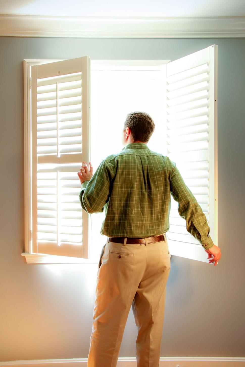 Free Image of Backside View of Man Standing at Window  