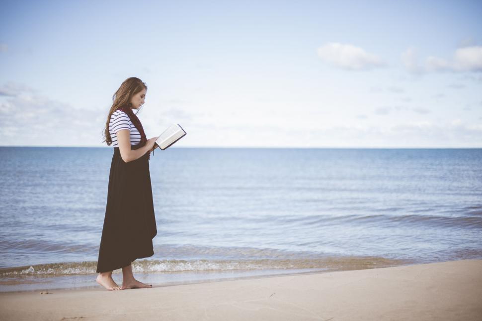 Free Image of Woman reading at the beach 