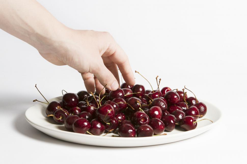 Free Image of Cherries and hand  