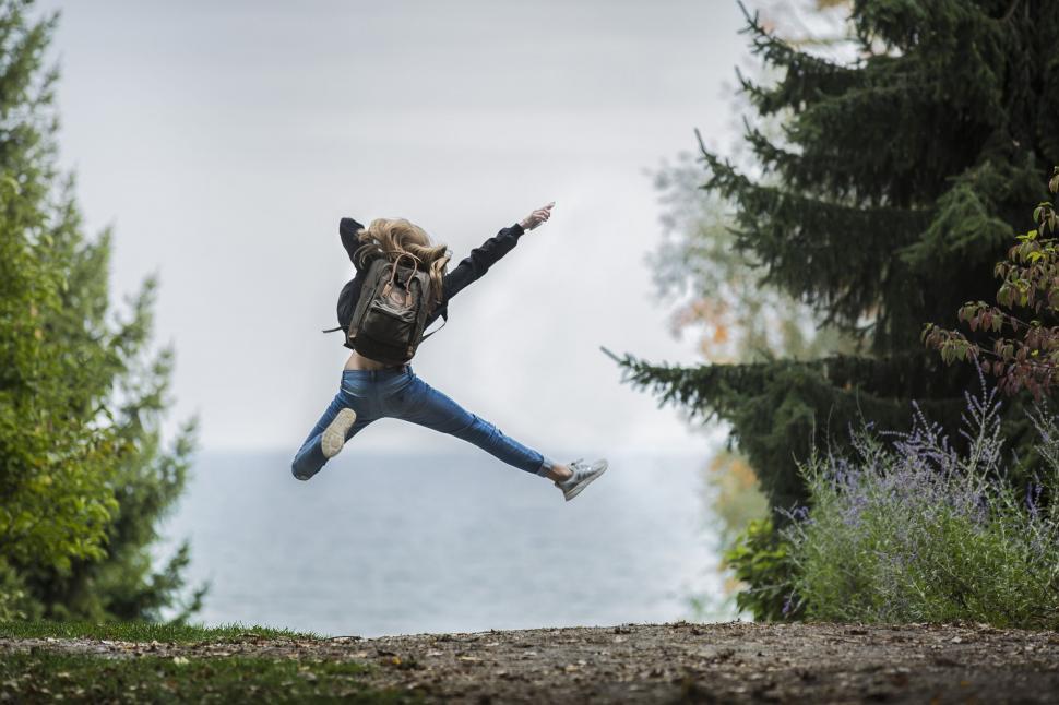 Free Image of Blonde Hair Girl Jumping in Excitement 