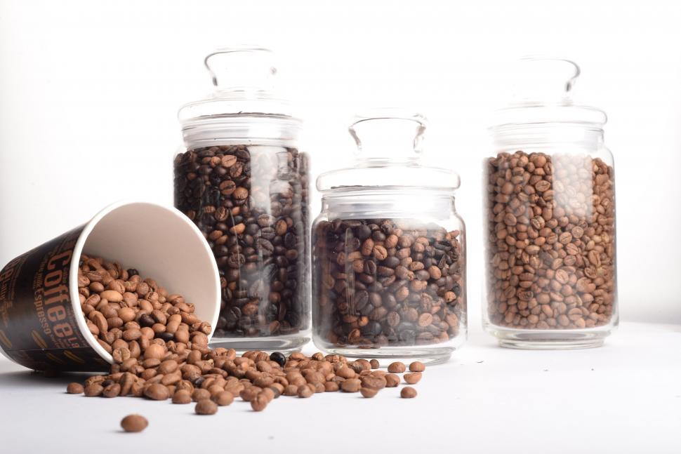 Free Image of Coffee beans spilling out of mug  