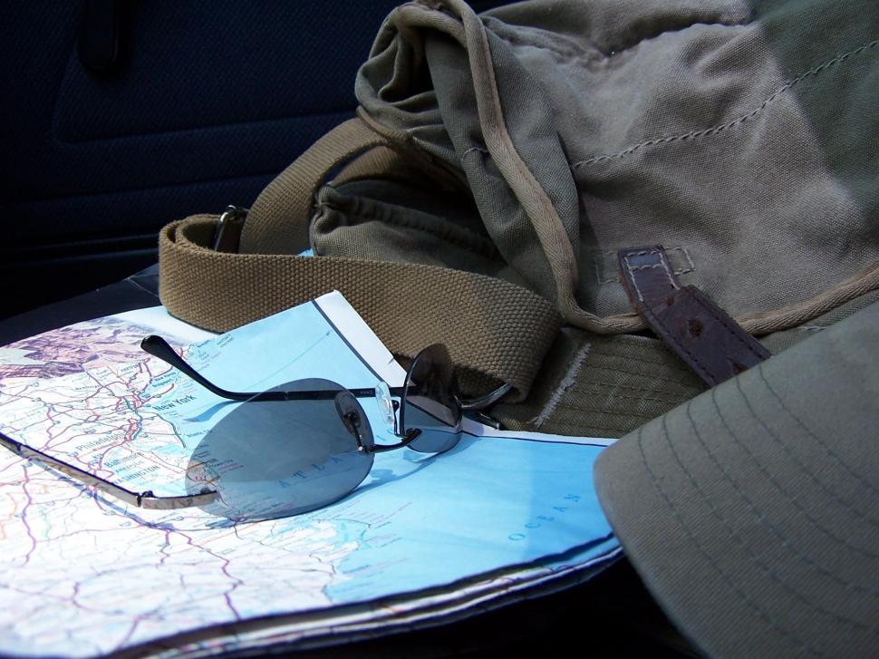 Free Image of Map and Sunglasses with Travel Bag  
