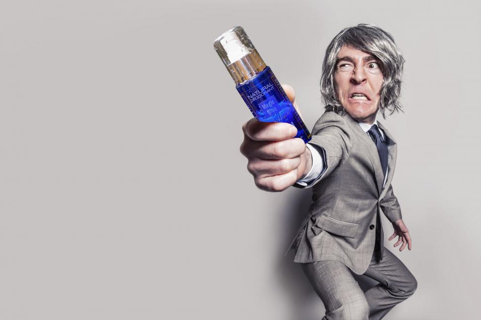 Free Image of Gray Hair Man with Deodorant Bottle  