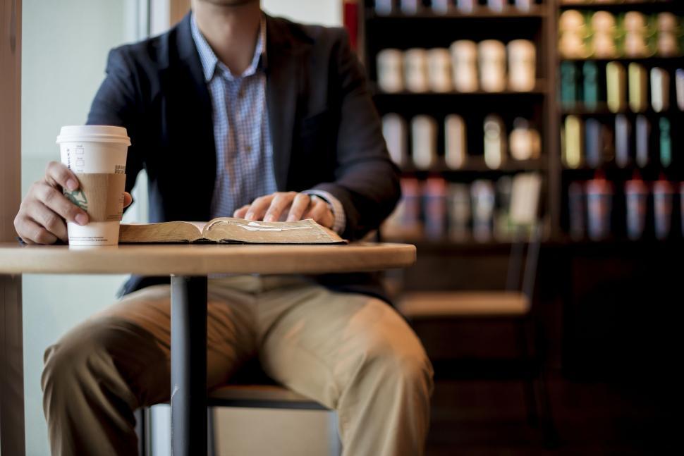 Free Image of Reading with Starbucks Coffee  