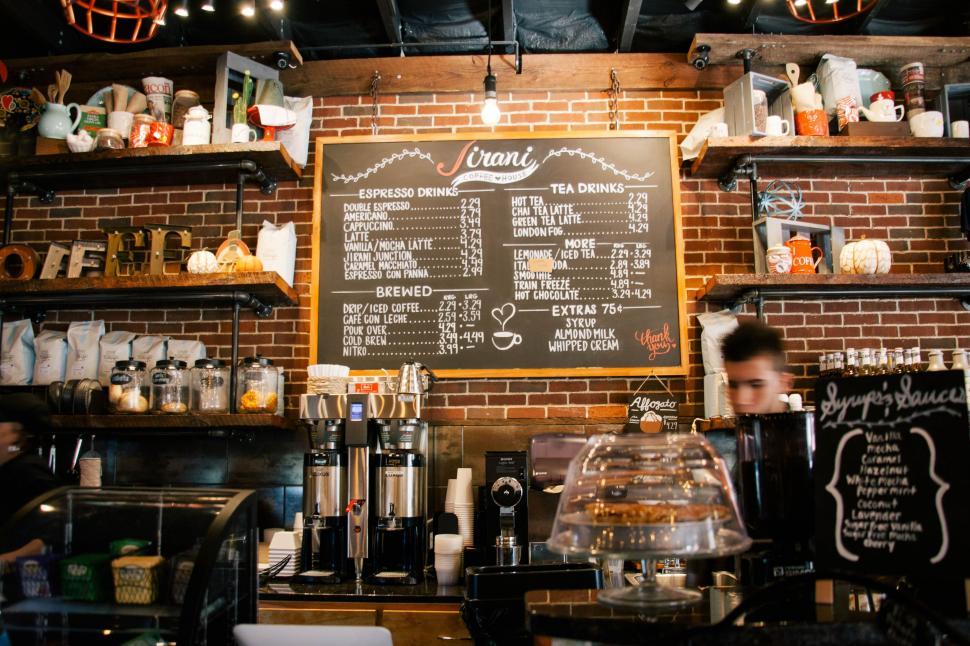 Free Image of Menu Board and Counter with blur view of man in Coffee Shop 