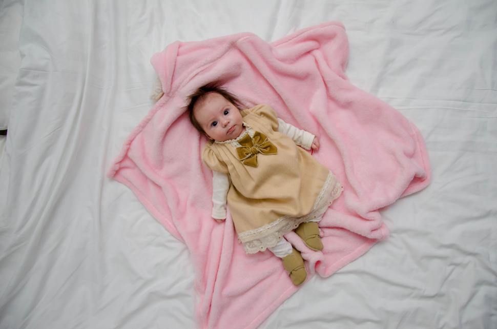 Free Image of Little Baby Girl lying on bed  