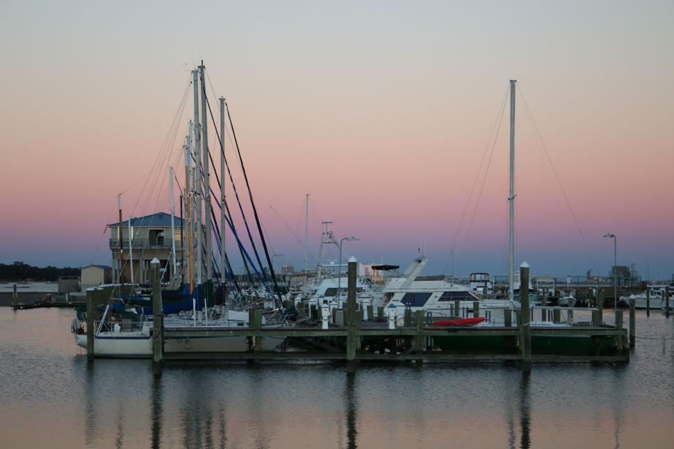 Free Image of Sailboats at dock with sunset sky  