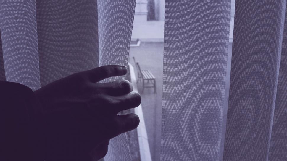 Free Image of Hand holding a room curtain  