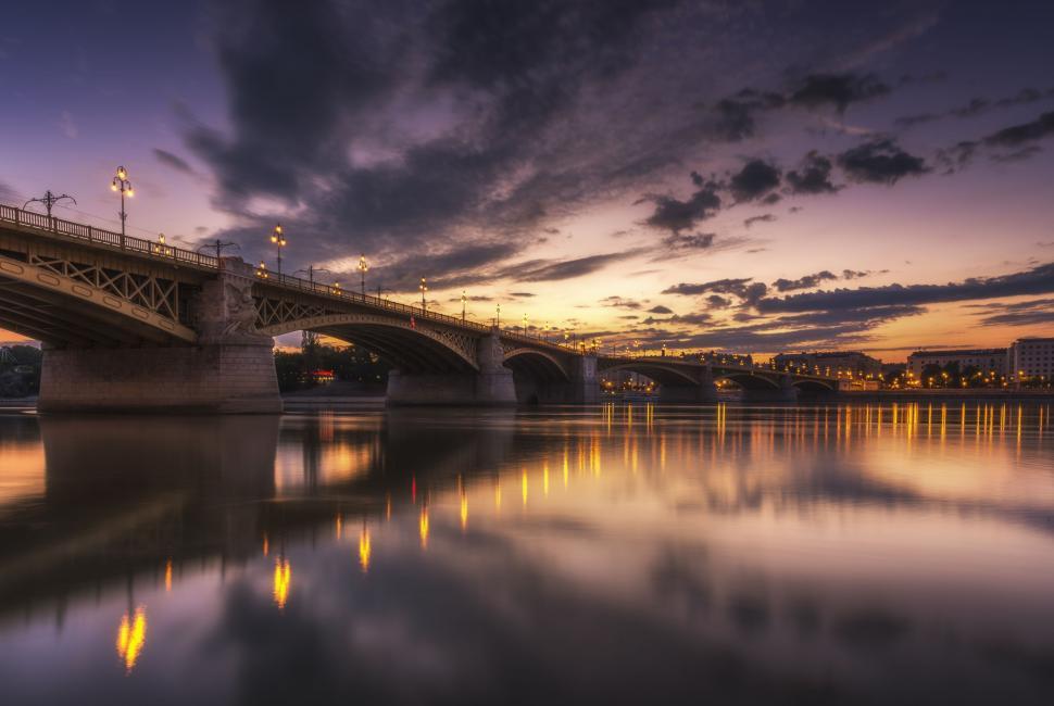 Free Image of Night View of River with reflection of bridge and sunset sky 
